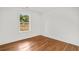 Bright bedroom featuring hardwood floors, a window with a view, and white walls and trim at 1835 Hawkins Se St, Smyrna, GA 30080