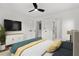 Well-lit bedroom features hardwood floors, ceiling fan, and doorway to a tiled modern bathroom at 1835 Hawkins Se St, Smyrna, GA 30080