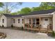 Charming one-story home with a cozy front porch featuring a seating area, perfect for relaxing outdoors at 1835 Hawkins Se St, Smyrna, GA 30080