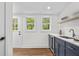 Modern wet bar featuring blue cabinets, quartz countertops, and a mini fridge at 1835 Hawkins Se St, Smyrna, GA 30080