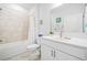 Bright bathroom with a white vanity, sink, and tiled shower featuring modern fixtures at 221 Hickory Bluffs Pkwy, Canton, GA 30114