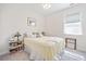 Cozy bedroom with a patterned quilt, small bedside lamps, and a window with natural light at 221 Hickory Bluffs Pkwy, Canton, GA 30114