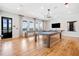 Billiard room featuring wooden floors, natural light, and a modern chandelier at 221 Hickory Bluffs Pkwy, Canton, GA 30114