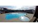 Large freeform community pool with ample deck space and neighborhood homes in the background at 221 Hickory Bluffs Pkwy, Canton, GA 30114