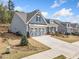 Well-maintained blue home with a two-car garage and beautifully landscaped front yard at 221 Hickory Bluffs Pkwy, Canton, GA 30114