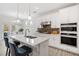 Bright kitchen featuring white cabinets, a large island with bar seating, and stainless steel appliances at 221 Hickory Bluffs Pkwy, Canton, GA 30114