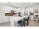Modern kitchen featuring white cabinets, stainless steel appliances, a large island, and stylish backsplash at 221 Hickory Bluffs Pkwy, Canton, GA 30114