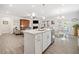 Bright open concept living room featuring an island with seating, modern kitchen, and dining area at 221 Hickory Bluffs Pkwy, Canton, GA 30114
