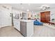 Bright living room featuring an island with stainless steel appliances, a ceiling fan, and stylish decor at 221 Hickory Bluffs Pkwy, Canton, GA 30114