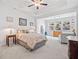 Spacious main bedroom with a tray ceiling, large windows overlooking the garden, and a cozy seating area at 221 Hickory Bluffs Pkwy, Canton, GA 30114