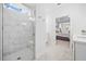 Modern tiled shower with glass door, window, and bench, leading to the bedroom at 221 Hickory Bluffs Pkwy, Canton, GA 30114
