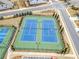Well maintained community tennis courts and surrounding homes and landscaping at 221 Hickory Bluffs Pkwy, Canton, GA 30114