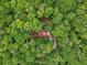 Aerial view of a secluded log home surrounded by lush, green trees at 2361 Mann Rd, Douglasville, GA 30134