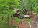 An aerial shot of a cozy log cabin surrounded by a dense forest at 2361 Mann Rd, Douglasville, GA 30134