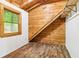 Bright attic room featuring wood ceiling, updated flooring and wood-paneled wall at 2361 Mann Rd, Douglasville, GA 30134