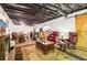 Wide view of finished basement highlighting the living area, kitchenette, and barn door accent at 2361 Mann Rd, Douglasville, GA 30134