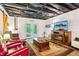 Cozy basement living area featuring comfortable seating, a TV, and stylish decor at 2361 Mann Rd, Douglasville, GA 30134