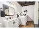 This bathroom features a white vanity, modern fixtures, and laundry machines for added convenience at 2361 Mann Rd, Douglasville, GA 30134