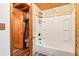 Cabin bathroom featuring wood-paneled walls, shower, and toilet at 2361 Mann Rd, Douglasville, GA 30134