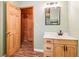 Bathroom featuring a wood vanity, modern fixtures, and a view into the adjacent room at 2361 Mann Rd, Douglasville, GA 30134