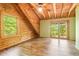 Bedroom featuring wood paneling, a window, and access to a private balcony at 2361 Mann Rd, Douglasville, GA 30134