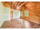 Bedroom boasting wood paneling, a ceiling fan, and natural light from windows at 2361 Mann Rd, Douglasville, GA 30134