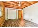 Bright bedroom featuring wood ceiling, updated flooring, and closet at 2361 Mann Rd, Douglasville, GA 30134