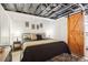 This bedroom features a comfortable bed, stylish decor, and a unique barn door for added character at 2361 Mann Rd, Douglasville, GA 30134