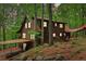 Charming log cabin home with lush greenery, covered parking and a connecting walkway at 2361 Mann Rd, Douglasville, GA 30134