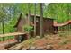 Charming log cabin home with lush greenery, covered parking and a connecting walkway at 2361 Mann Rd, Douglasville, GA 30134