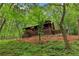Exterior view of house nestled among lush green trees with a rustic design at 2361 Mann Rd, Douglasville, GA 30134