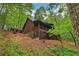 Charming log cabin with a cozy porch nestled among lush trees at 2361 Mann Rd, Douglasville, GA 30134