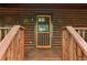 Charming log cabin entrance with a decorative door and rustic star accents at 2361 Mann Rd, Douglasville, GA 30134