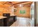 Rustic cabin kitchen features wood-paneled walls, black appliances, and wood countertops at 2361 Mann Rd, Douglasville, GA 30134