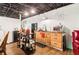 Basement kitchenette with wood cabinets, functional island, and sleek black appliances at 2361 Mann Rd, Douglasville, GA 30134