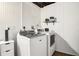 Laundry area with modern washing machines, white walls, and sleek storage at 2361 Mann Rd, Douglasville, GA 30134