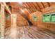 Open cabin living room features wood-paneled walls, wood floors, and staircase at 2361 Mann Rd, Douglasville, GA 30134