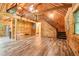 Open cabin living room features wood-paneled walls, wood floors, and staircase at 2361 Mann Rd, Douglasville, GA 30134