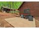 Cozy patio with stylish seating area and lush green surroundings near a charming log cabin at 2361 Mann Rd, Douglasville, GA 30134