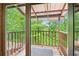 This porch features a wooden railing and scenic views of the surrounding forest at 2361 Mann Rd, Douglasville, GA 30134
