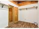 Walk-in closet with new floor, wood door and shelving at 2361 Mann Rd, Douglasville, GA 30134