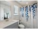Bathroom with a gray vanity, white countertops, and a decorative blue shower curtain at 4389 Treadle Sw Rd, Mableton, GA 30126