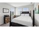 Bright bedroom with large windows, dark wood frame bed, and modern decor at 4389 Treadle Sw Rd, Mableton, GA 30126