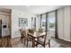 Dining area with hardwood floors, natural light, a wooden table, six chairs and grey curtains at 4389 Treadle Sw Rd, Mableton, GA 30126