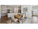 Dining area featuring hardwood floors, open to kitchen, light-gray walls and dining table at 4389 Treadle Sw Rd, Mableton, GA 30126