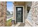 Home's inviting front door with sidelight, brick wall, and siding detail, and a decorative item on the house at 4389 Treadle Sw Rd, Mableton, GA 30126