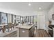Open-concept kitchen with stainless steel appliances, granite countertops, and an island with a sink at 4389 Treadle Sw Rd, Mableton, GA 30126