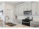 Modern kitchen featuring granite countertops, stainless steel appliances and plenty of natural light at 4389 Treadle Sw Rd, Mableton, GA 30126