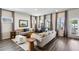Comfortable living room with ample seating, hardwood floors, neutral paint, and lots of natural light at 4389 Treadle Sw Rd, Mableton, GA 30126