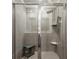 Walk-in shower with neutral tile and a bench in a modern bathroom at 4389 Treadle Sw Rd, Mableton, GA 30126